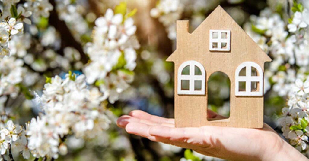 A cardboard house in someone's hand