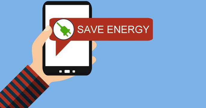 A hand holding a smartphone with a dialog box saying "Save Energy".