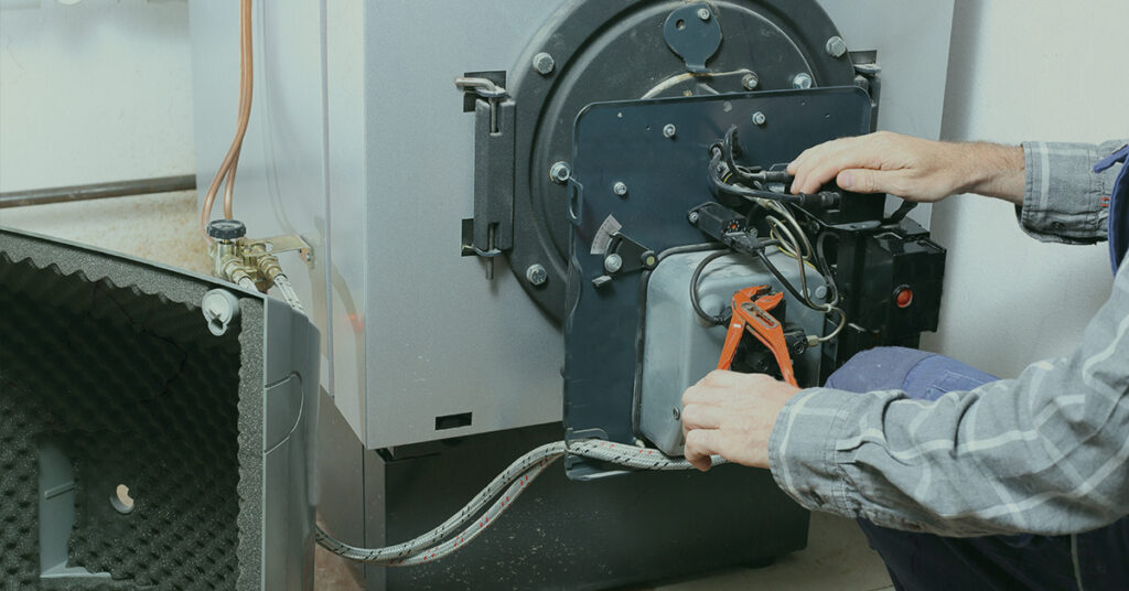 technician servicing a boiler