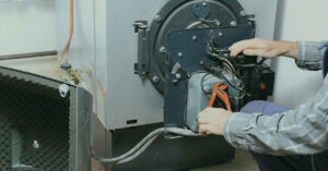technician servicing a boiler