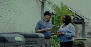 HVAC technician explaining heat pumps and furnaces
